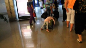 tired-girl-hitches-a-ride-on-her-fathers-suitcase-1024x576